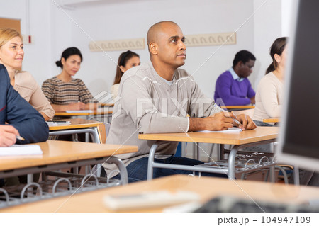 Focused man working at adult education class Focused man working at adult education class 104947109