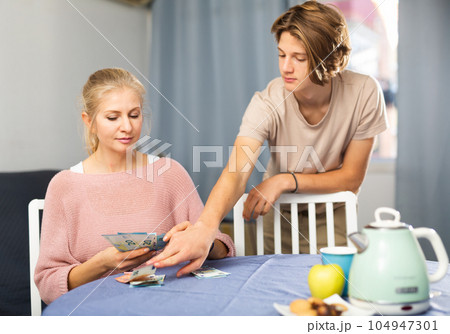 Mother giving some cash her teenager son 104947301