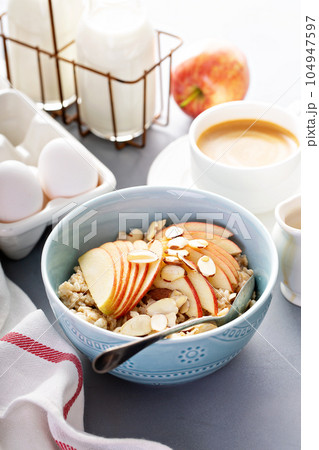 Healthy oatmeal with sliced apple and almonds 104947597