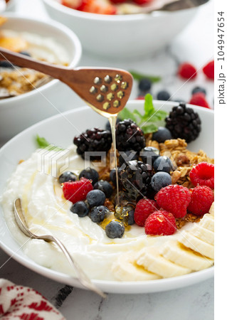 Yogurt bowl with berry, fruit and granola 104947654