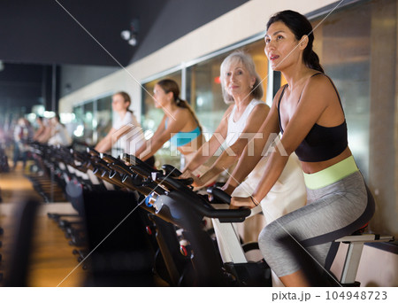 Asian woman with fitness bike in gym 104948723