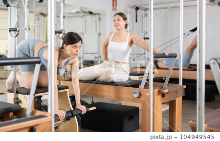 Young asian woman practicing pilates on wunda chair 104949545