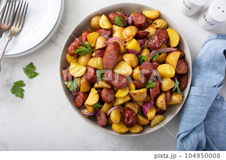 Traditional breakfast dish, potatoes with sausage Traditional breakfast dish, potatoes with sausage 104950008