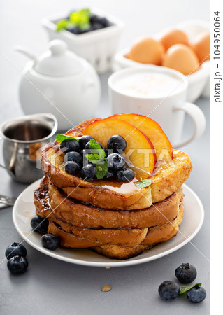 French toasts with fresh fruit for breakfast 104950064