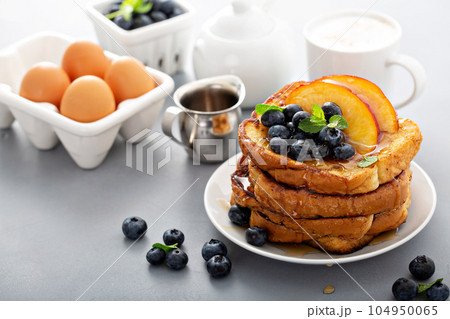 French toasts with fresh fruit for breakfast 104950065