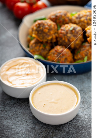 Sauasage balls with cheese and sauce 104950096