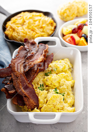 Full breakfast with scrambled eggs, bacon and potatoes Full breakfast with scrambled eggs, bacon and potatoes 104950157