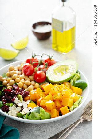 Vegan lunch bowl with chickpeas and roasted squash 104950169