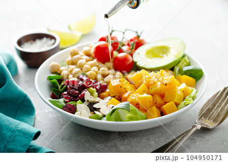 Vegan lunch bowl with chickpeas and roasted squash 104950171