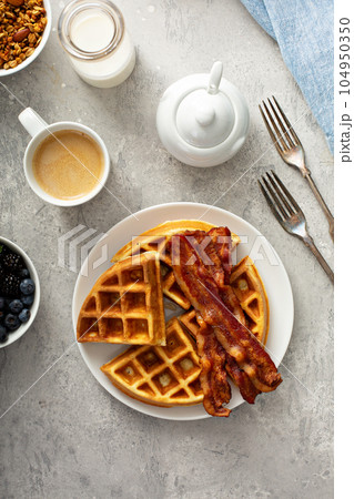 Breakfast plate with waffles and bacon 104950350