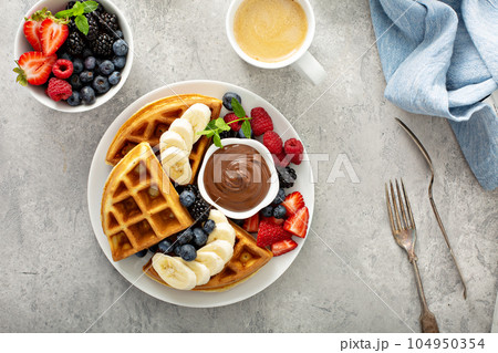 Waffles with berries and chocolate for breakfast Waffles with berries and chocolate for breakfast 104950354