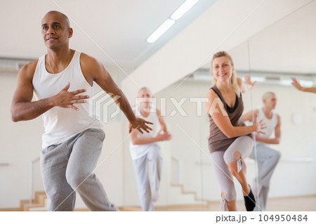 Man dancing at group lesson in studio 104950484