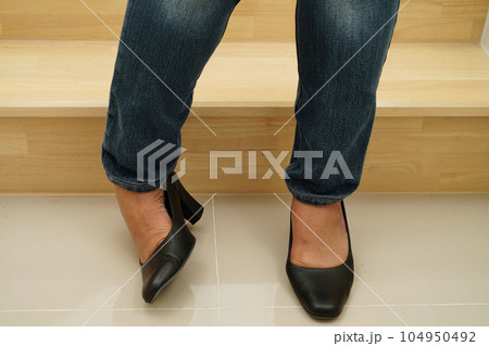 Asian business woman pain ankle, foot with leg cramp and fall down the stairs because slippery surfaces in office. 104950492
