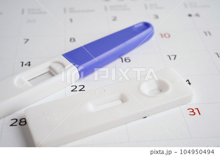 Pregnancy test for female on calendar, ovulation day. Pregnancy test for female on calendar, ovulation day. 104950494