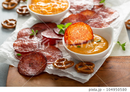 Salami chips baked in the oven with cheese sauces 104950580