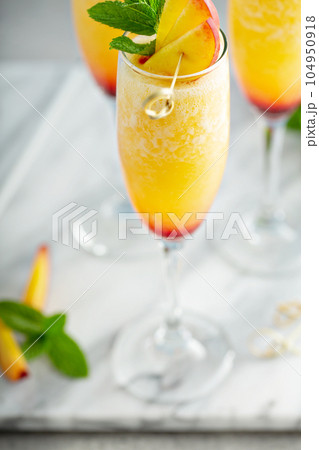 Summertime peach mimosas or bellinis Summertime peach mimosas or bellinis 104950918