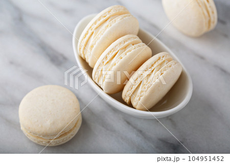 Vanilla macarons in a little bowl Vanilla macarons in a little bowl 104951452