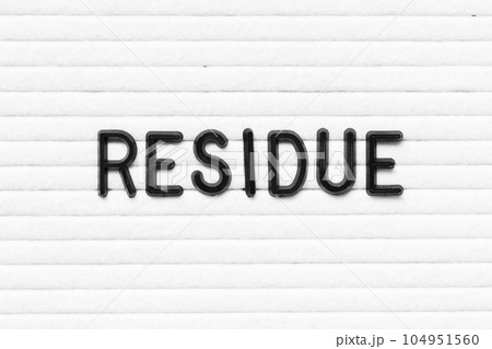 Black letter in word residue on white felt board background 104951560
