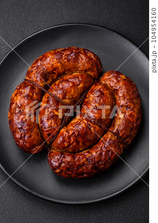Delicious grilled sausage in the form of a ring with salt, spices and herbs Delicious grilled sausage in the form of a ring with salt, spices and herbs 104954160