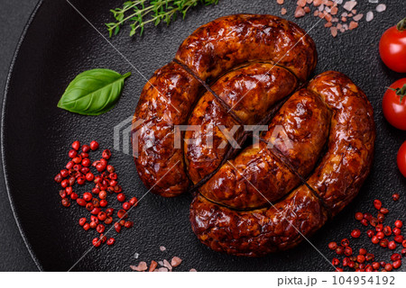 Delicious grilled sausage in the form of a ring with salt, spices and herbs Delicious grilled sausage in the form of a ring with salt, spices and herbs 104954192