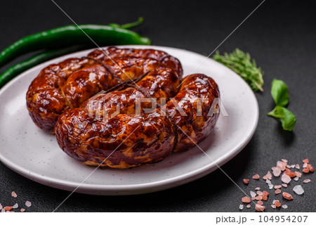 Delicious grilled sausage in the form of a ring with salt, spices and herbs Delicious grilled sausage in the form of a ring with salt, spices and herbs 104954207