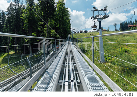 The point of view from the first person on the extreme attraction of Roller Rodelban in mountains. 104954381