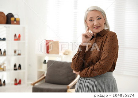 Confident female business owner in her boutique 104955874