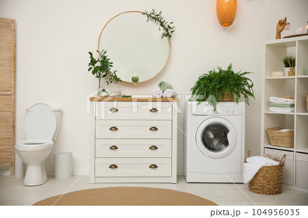 Elegant interior of modern bathroom with green plants 104956035
