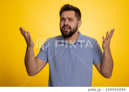 Man raising hands in indignant expression ask why what reason of failure demonstrating disbelief 104956094