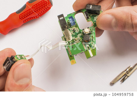 board in hand on a white background with a screwdriver 104959758