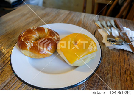 Salt and cheese bagel served on the plate Salt and cheese bagel served on the plate 104961896
