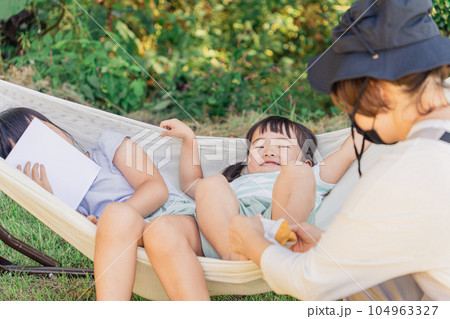 キャンプ場で靴下を履かせるママと子供 104963327
