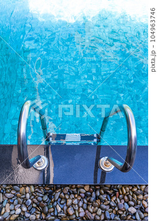 Swimming pool with stair in day time Swimming pool with stair in day time 104963746