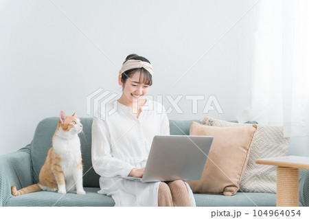 家で猫と一緒にテレワーク・リモートワークする女性 104964054