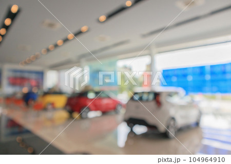 new cars in showroom blurred defocused background 104964910