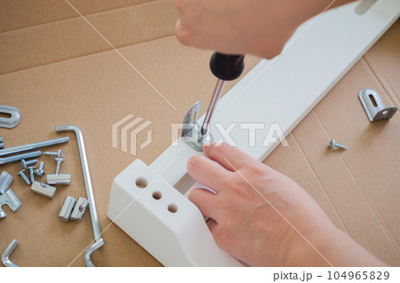 Assembly furniture using screwdriver at home Assembly furniture using screwdriver at home 104965829