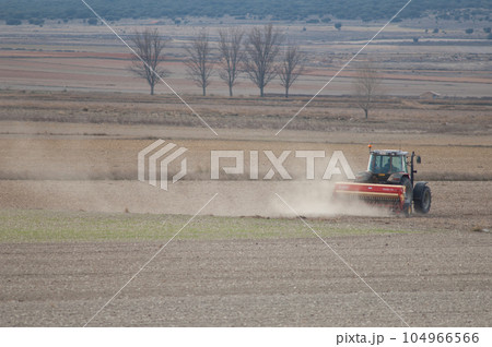 Tractor working in the field. 104966566