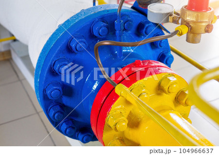 Metal bolting of pipes is painted with new yellow, red and blue paint. Part of gasification Metal bolting of pipes is painted with new yellow, red and blue paint. Part of gasification 104966637