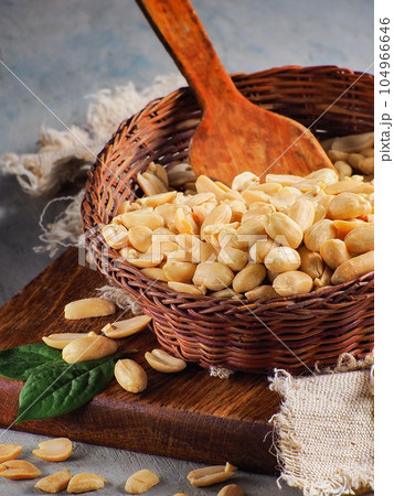 Peeled peanuts in wicker bowl. Village still life. Advertising photo of nuts for online store or 104966646