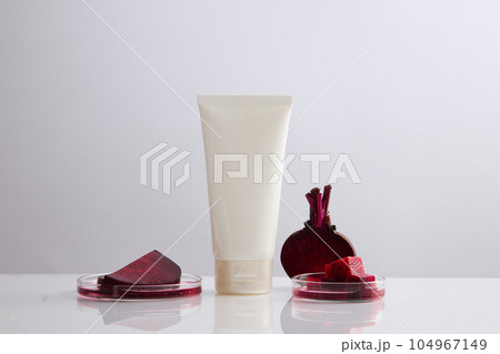 Minimal scene of a cosmetic container with glass petri dishes containing beetroot slices. Beetroot (Beta vulgaris) can help you treat pigmentation Minimal scene of a cosmetic container with glass petri dishes containing beetroot slices. Beetroot (Beta vulgaris) can help you treat pigmentation 104967149