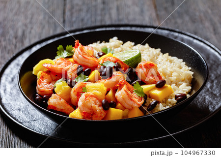 shrimps with beans, mango, brown rice in bowl shrimps with beans, mango, brown rice in bowl 104967330
