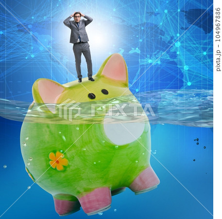 Businessman in debt concept with piggybank Businessman in debt concept with piggybank 104967886