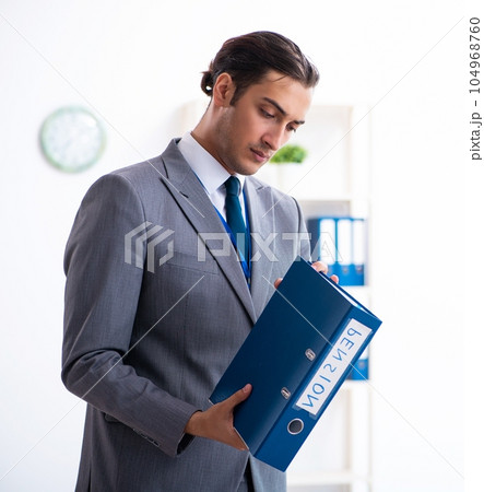 Young male accountant working in the office 104968760