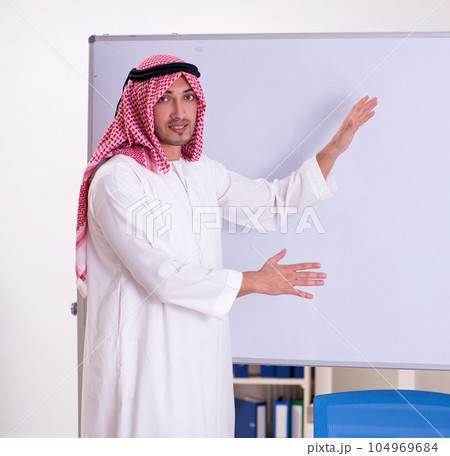 Arab teacher in front of whiteboard 104969684