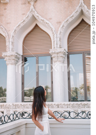 Beautiful lady watching the famous hotel in Las Vegas, standing in the busy city. Famous tourist attraction in USA on vacation in Las Vegas. Beautiful lady watching the famous hotel in Las Vegas, standing in the busy city. Famous tourist attraction in USA on vacation in Las Vegas. 104970913