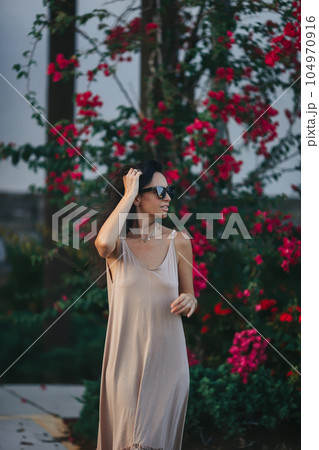 Happy young woman outdoor in the park walking at summer day 104970916