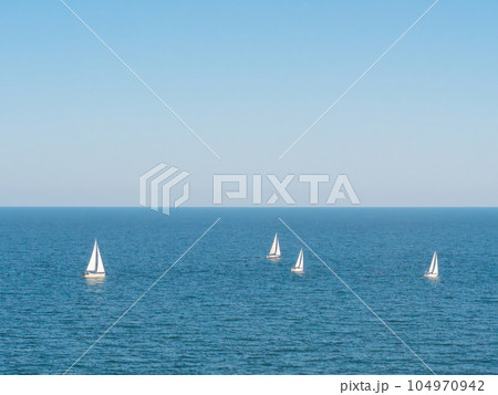 Sailing boat yacht or sailboat group regatta race on sea or ocean water.  104970942