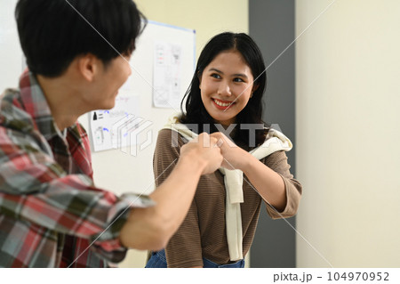 Group of creative business colleagues giving each other high five, celebration for teamwork achievement Group of creative business colleagues giving each other high five, celebration for teamwork achievement 104970952