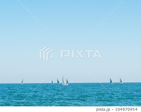 Sailing boat yacht or sailboat group regatta race on sea or ocean water.  104970954