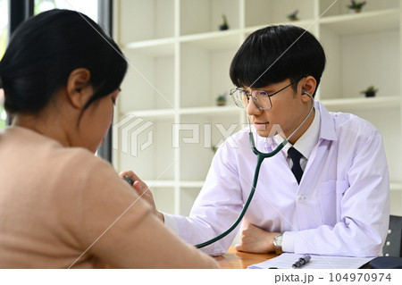 Doctor using stethoscope to checking heart and lungs of patient. ,Medical, consultation, diagnostic and health care concept 104970974
